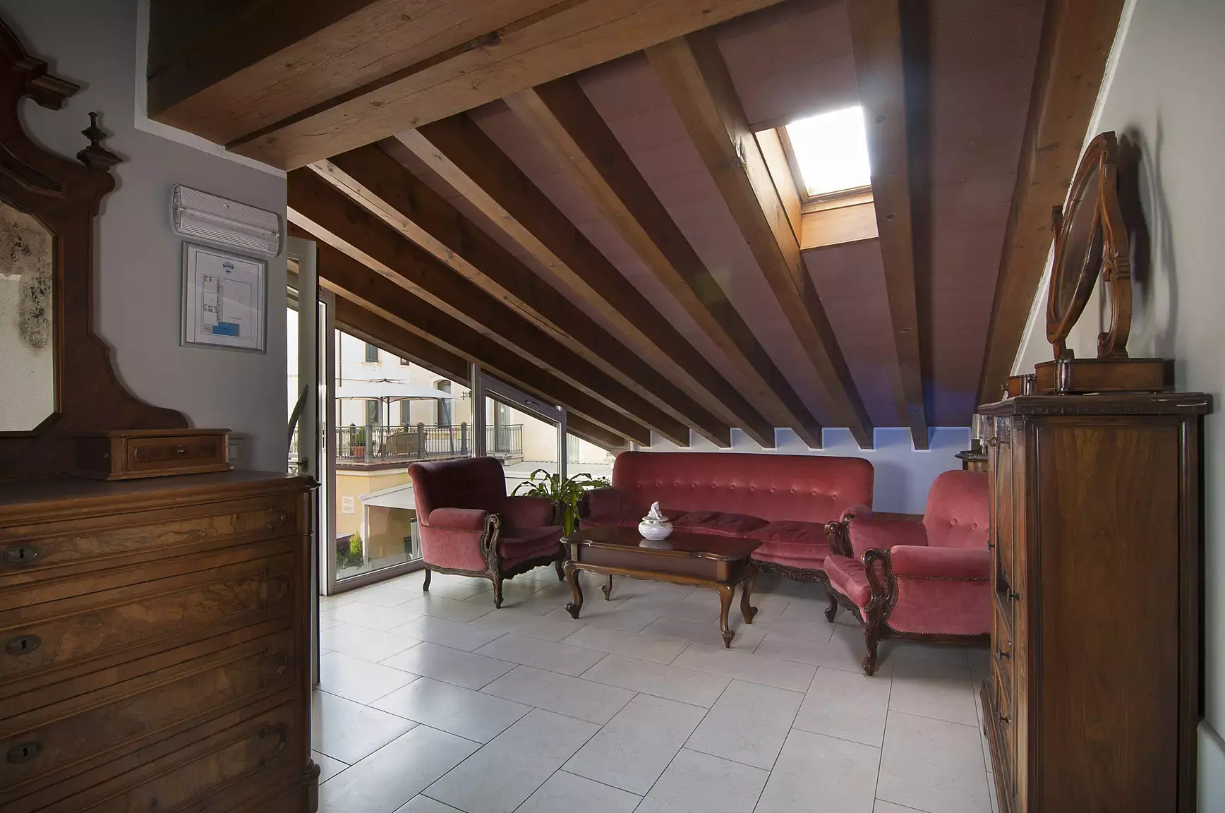 Elegante portico esterno dell'Albergo Fontana a Verona con vista sugli spazi verdi e l'area relax, un ambiente riparato e tranquillo per godersi momenti di sosta all'aria aperta.